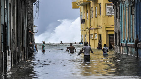Habaneros wade through floodwaters near El Malecon after Hurricane Irma