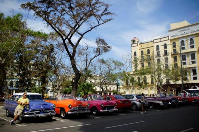A vintage car driver waits for tourists after Hurricane Irma caused flooding and a blackout, in Havana
